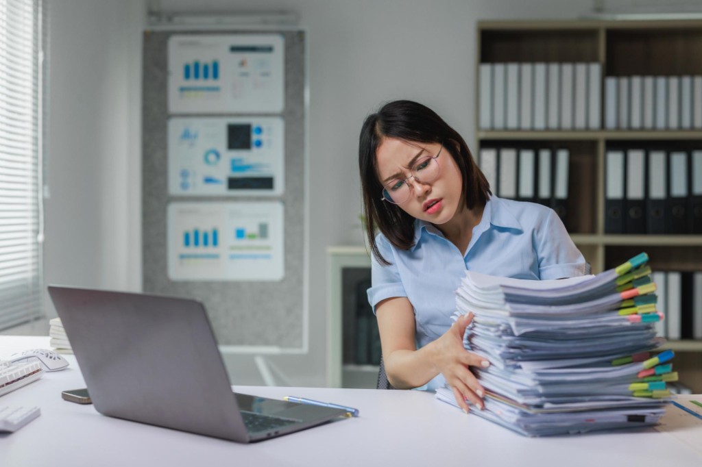 Procurement professional overwhelmed by manual paperwork and spreadsheets